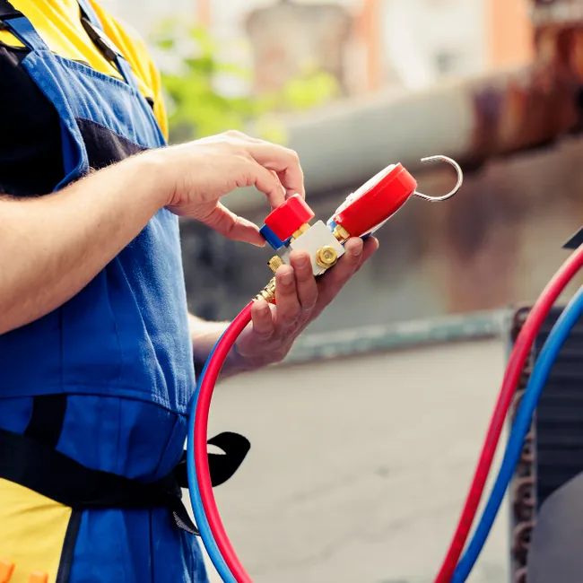 Close-up of Freshwind AC Service gas refilling pressure gauge