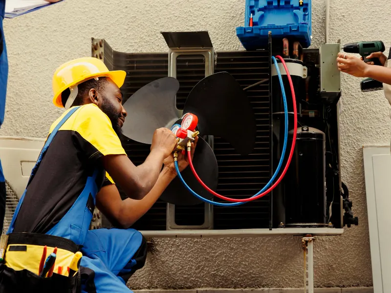 Freshwind AC Service technicians working together on an outdoor AC installation in Greater Noida