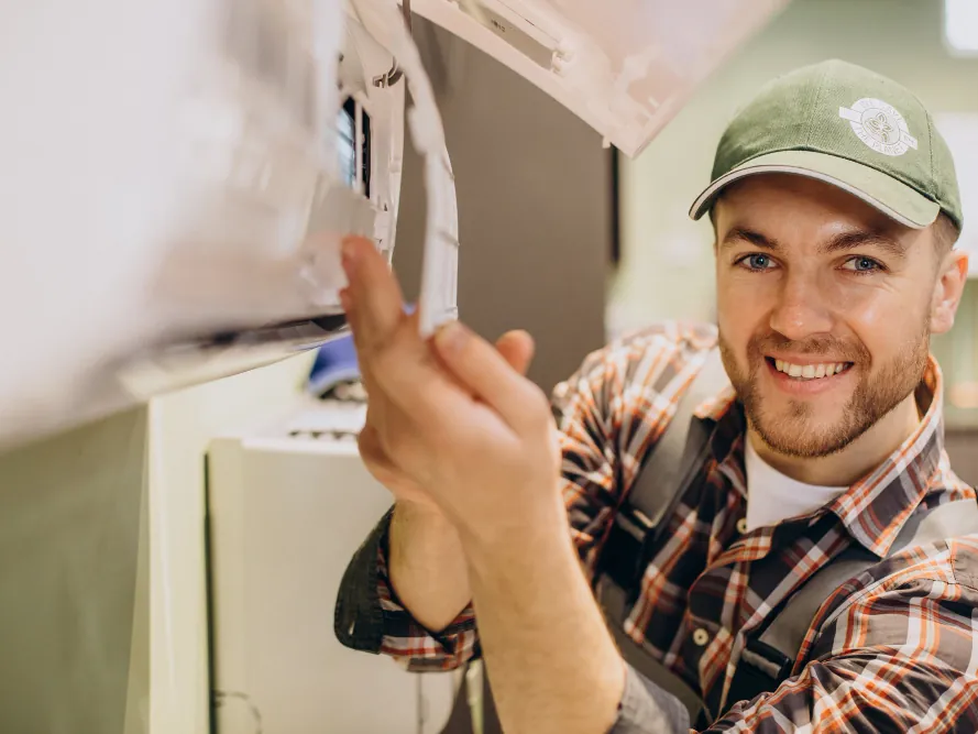 Freshwind AC Service technician servicing a home split AC unit in Greater Noida